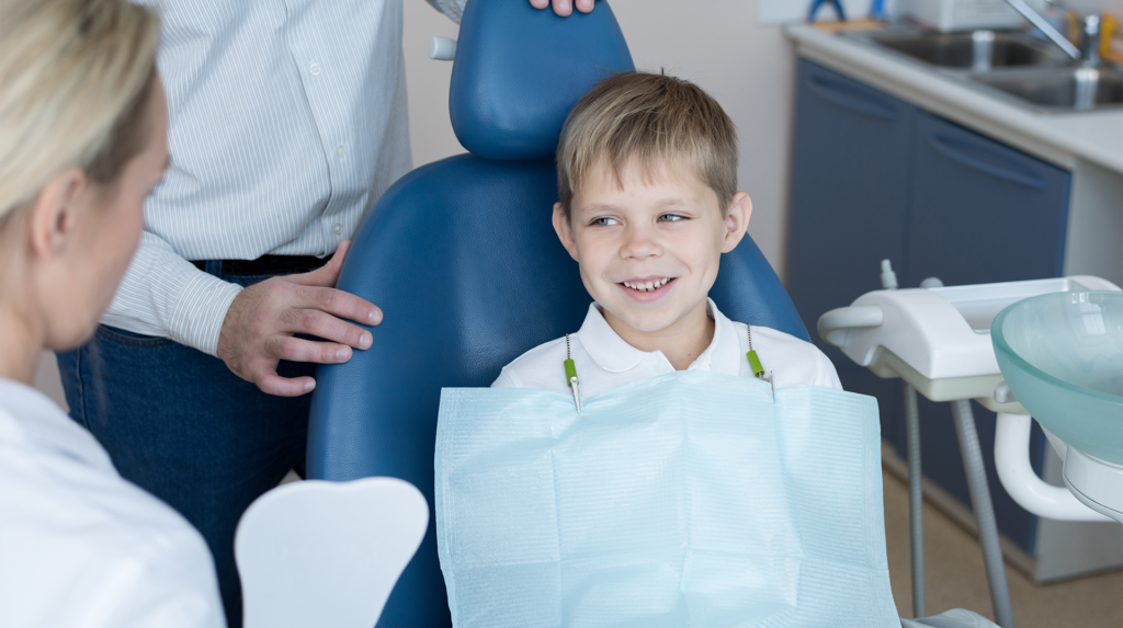 young boy smiling at the surgeon